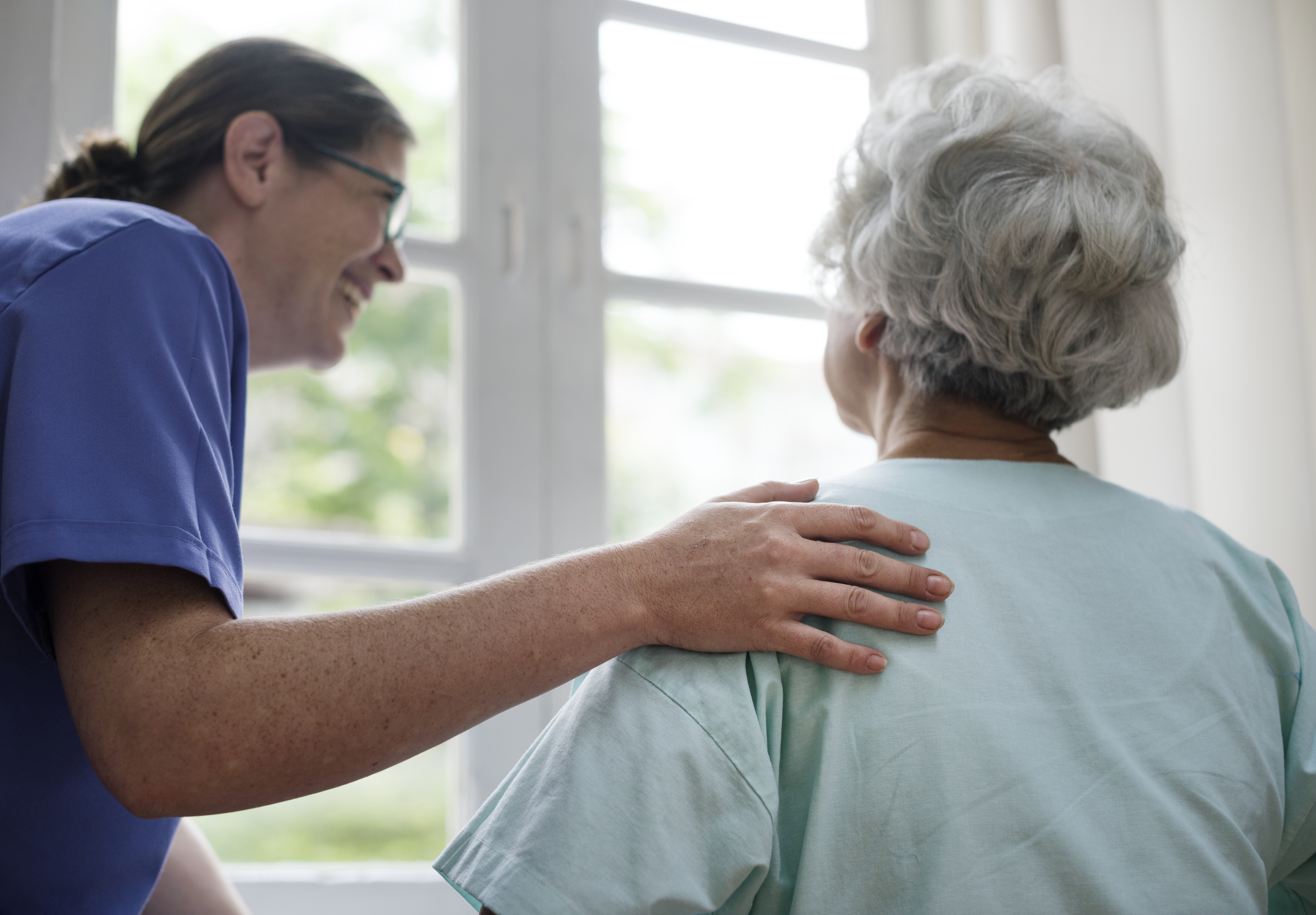 nurse taking care old woman